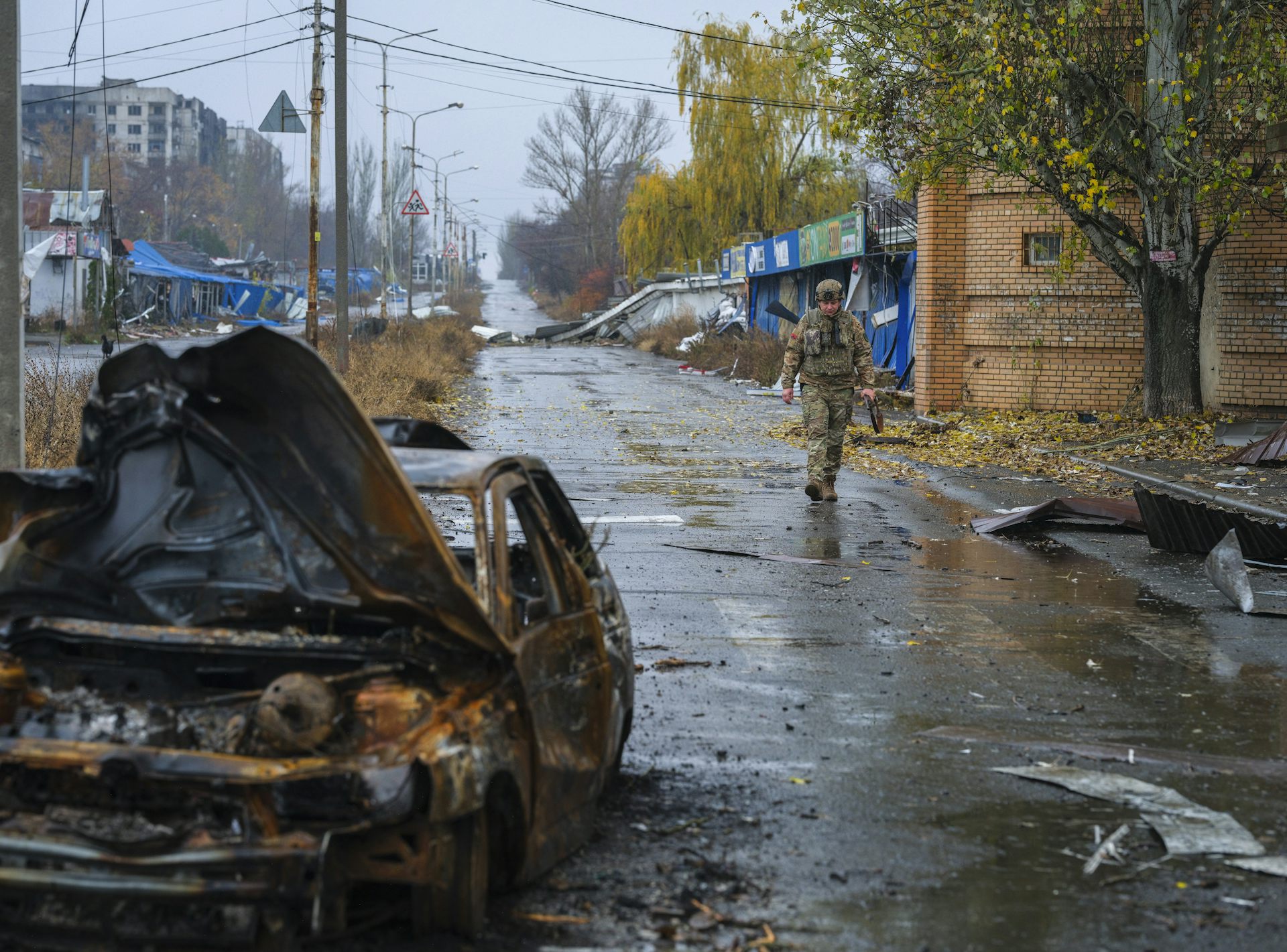 A Ukrainian serviceman walking in a damaged area of the frontline city of Kostyantynivka.