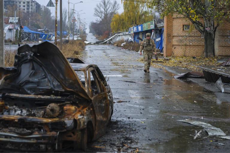 A Ukrainian serviceman walking in a damaged area of the frontline city of Kostyantynivka.