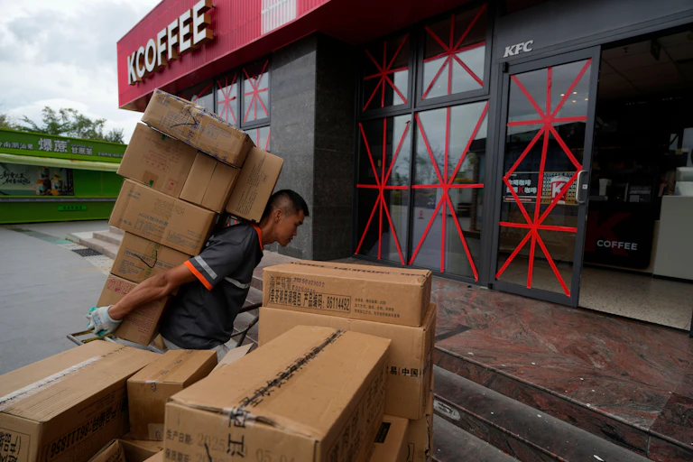 A delivery man shouldering his parcels in Beijing, China.