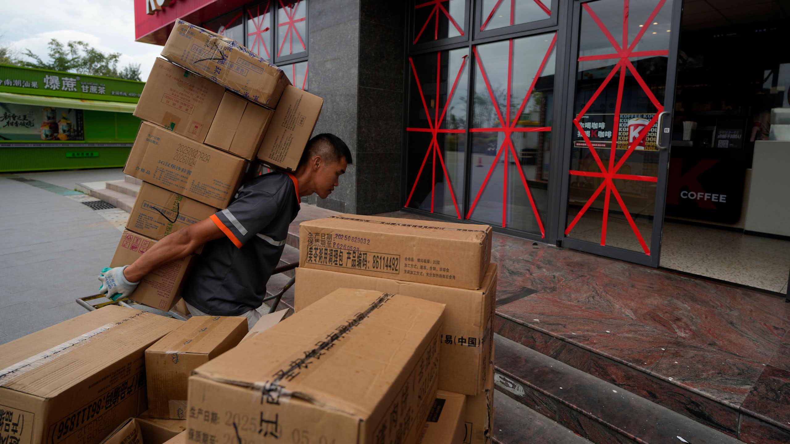 A delivery man shouldering his parcels in Beijing, China.