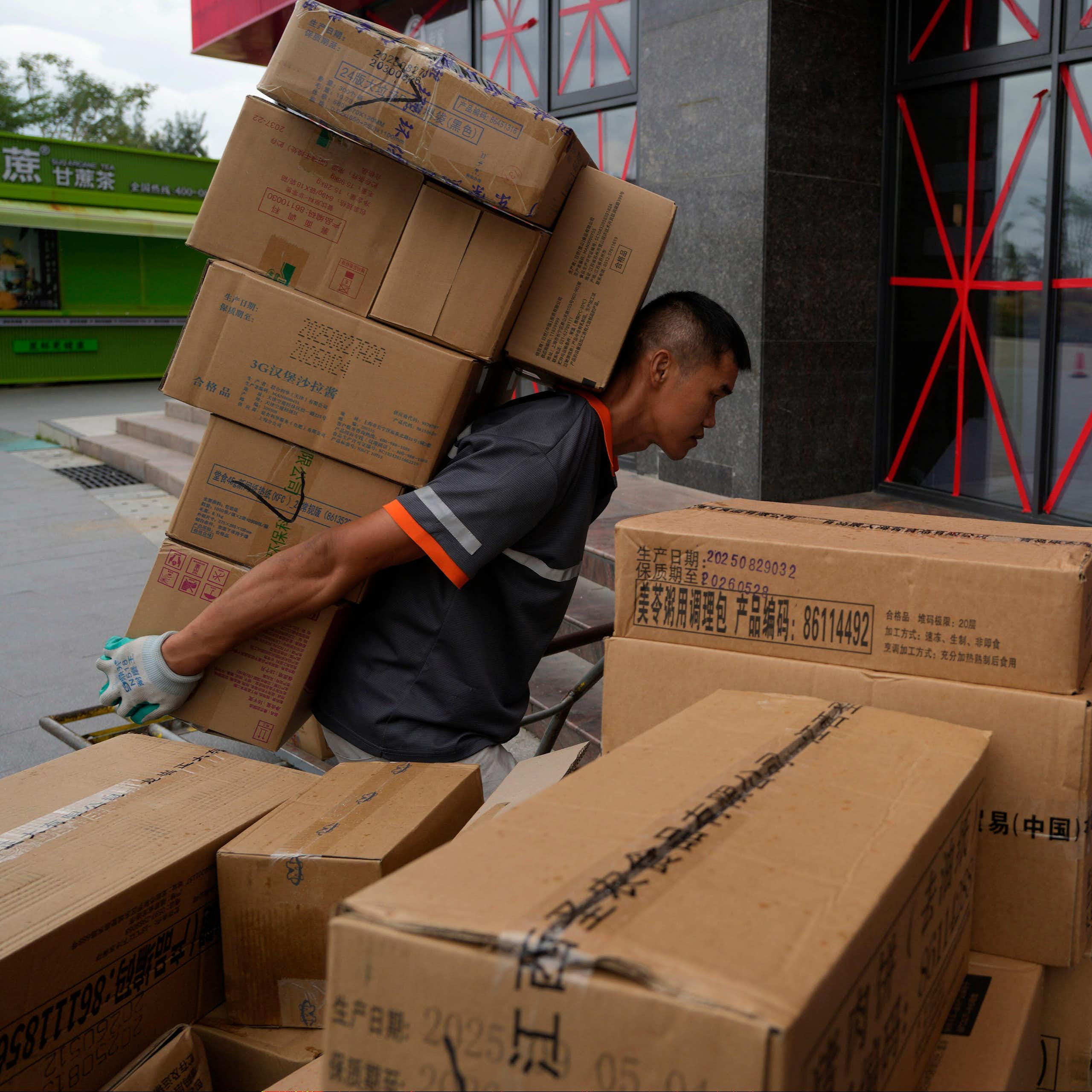 A delivery man shouldering his parcels in Beijing, China.