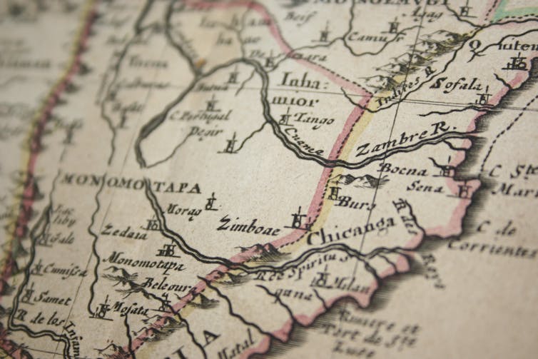 A historical map, slightly blurred on the edges, showing coloured lines and mountains.