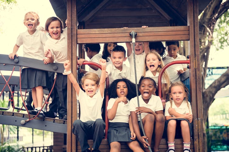 Happy primary school children on play equipment
