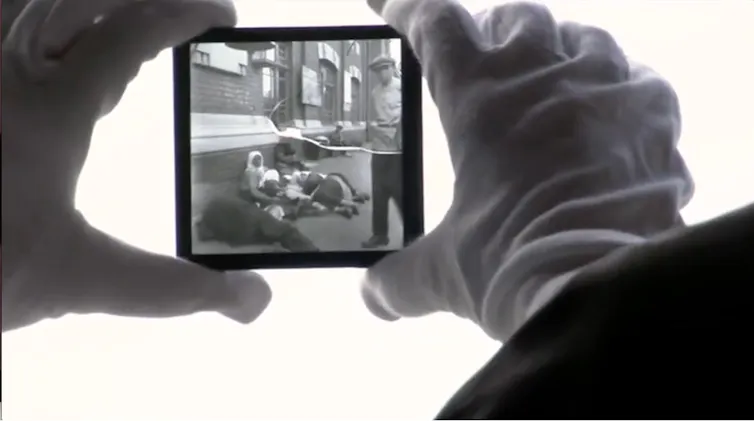 Hands holding a celluloid frame