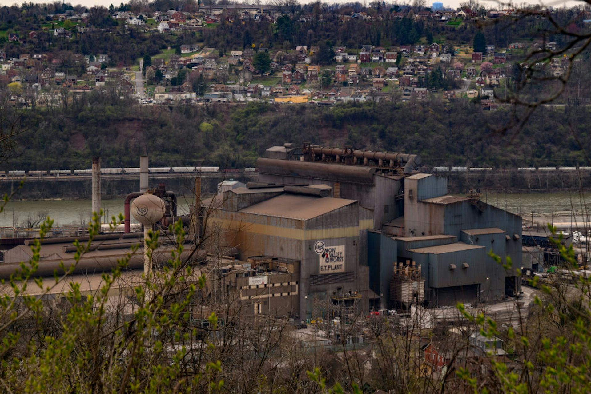 View of steel plant and river with residential homes in distance