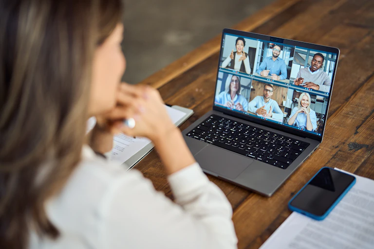 woman on a laptop in an online meeting with colleagues