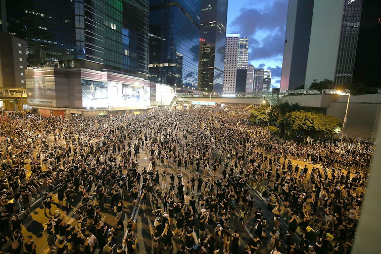 Crowds of people on roads in dark
