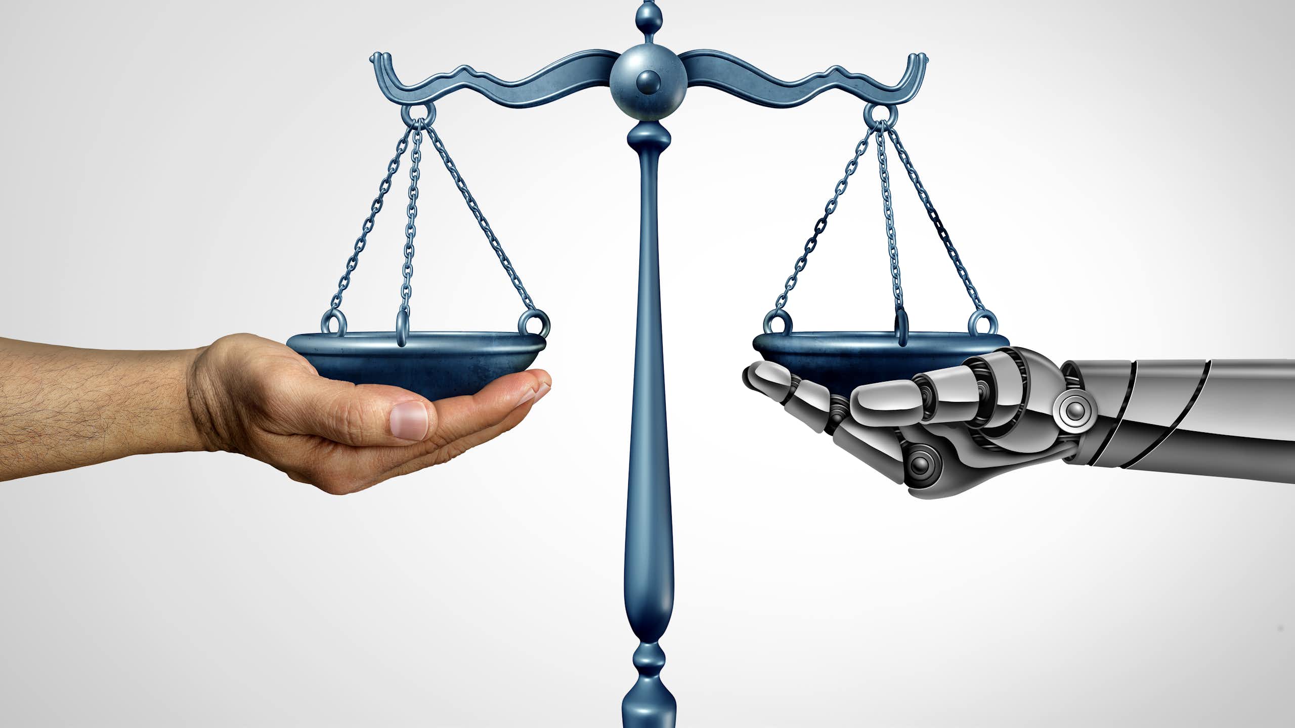 A human hand holds one side of a scale while the other is held by a robot hand.