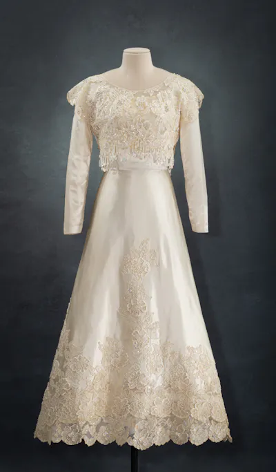 A white sequined dress displayed on a headless mannequin.