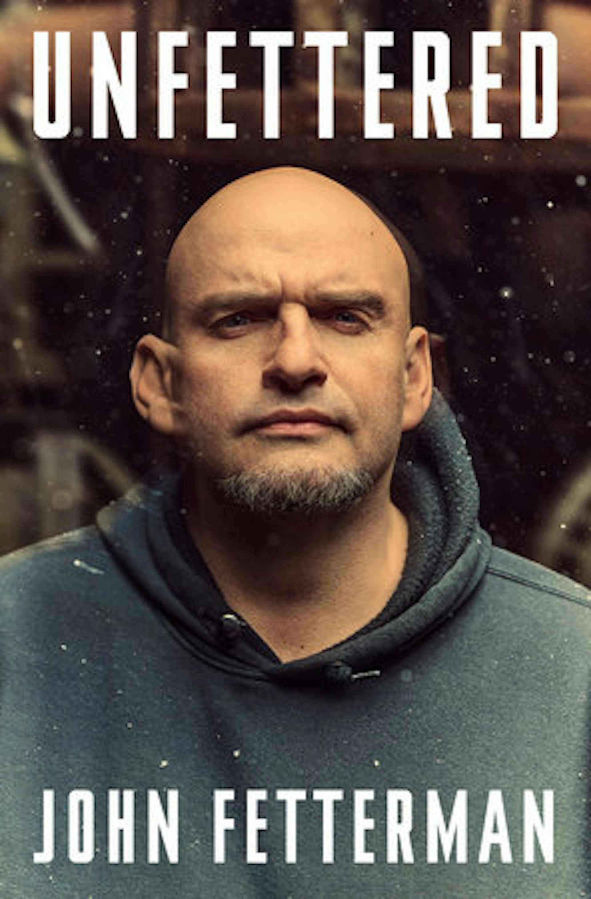 Book cover of bald man dressed in dark hoodie with words 'Unfettered' at top and 'John Fetterman' at bottom