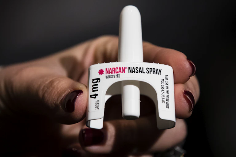 Hand holding naloxone nasal spray