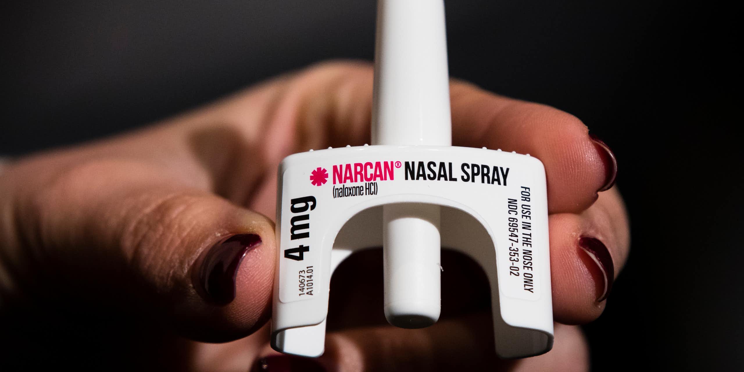 Hand holding naloxone nasal spray