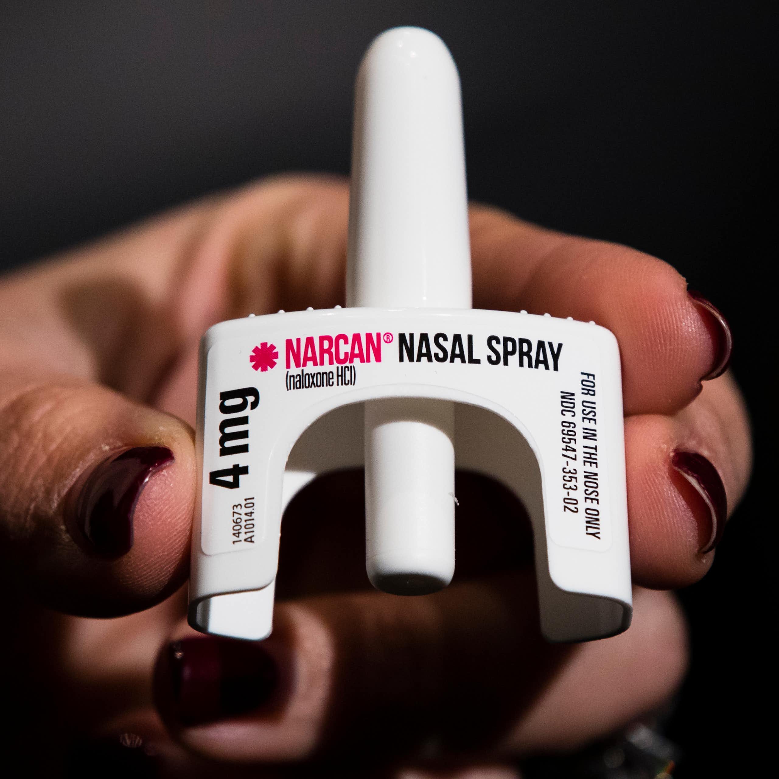 Hand holding naloxone nasal spray