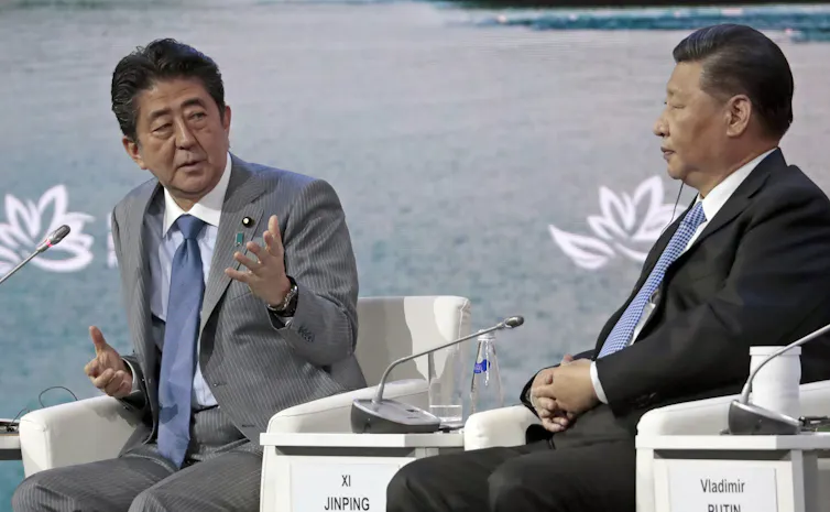 Shinzo Abe and Xi Jinping sat next to each other.
