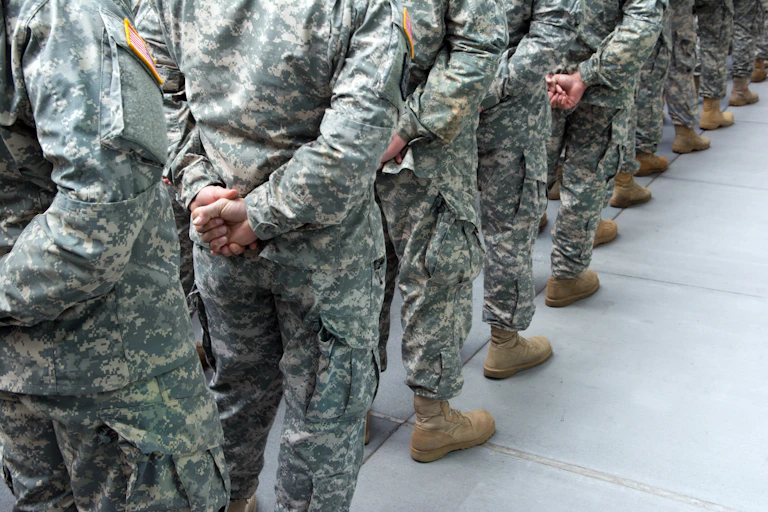 A long line of people dressed in military uniforms.