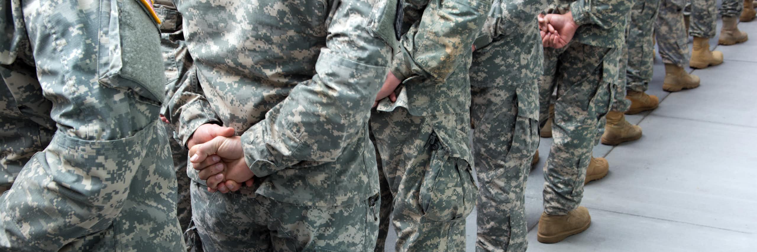 A long line of people dressed in military uniforms.