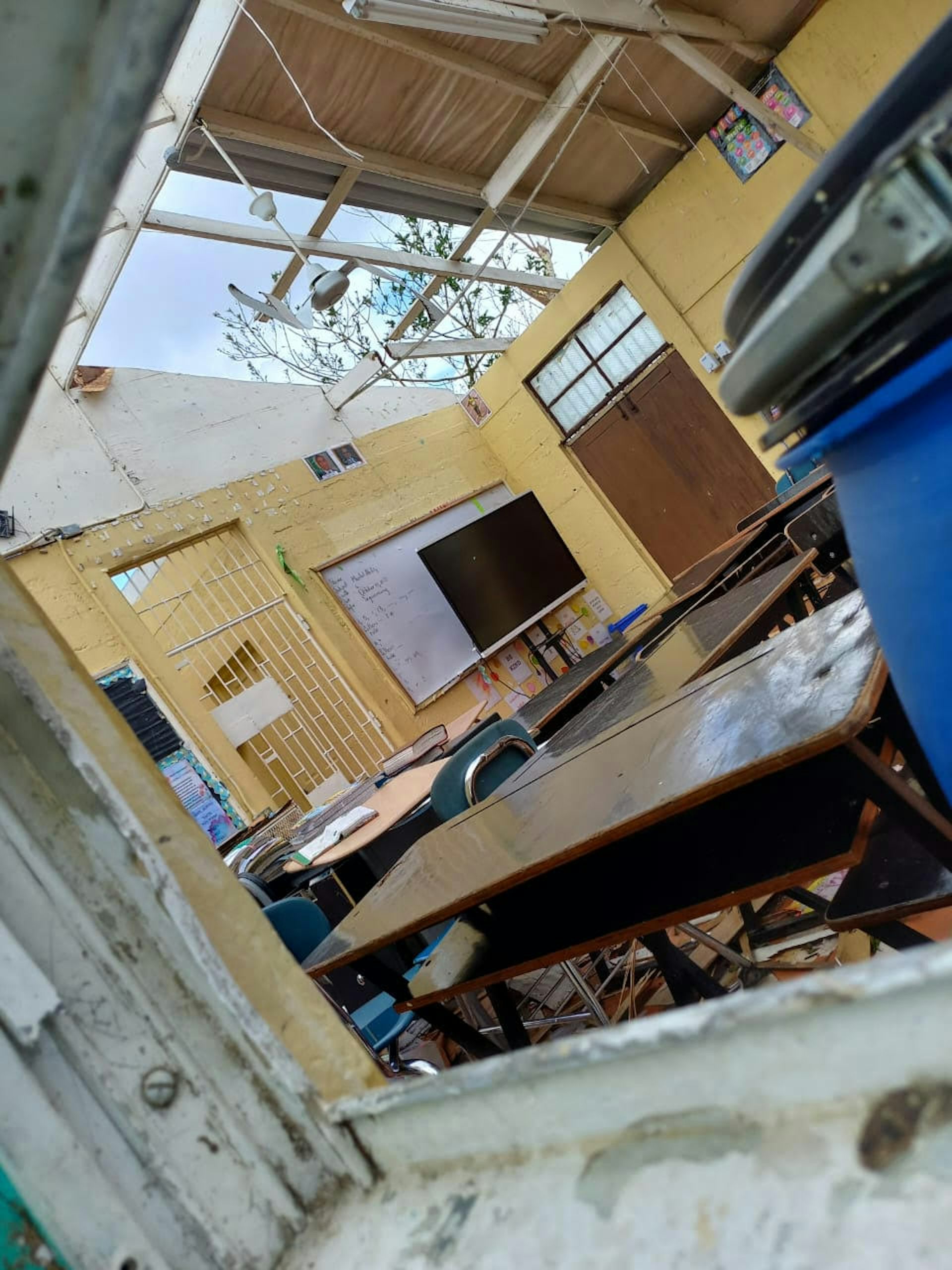 A school building with a gap in the roof.