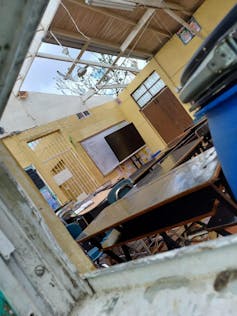A school building with a gap in the roof.