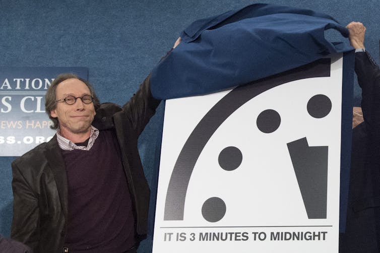 Lawrence Krauss, pictured with the Doomsday Clock in 2016, has been linked to Jeffrey Epstein. Michael Reynolds/AAP