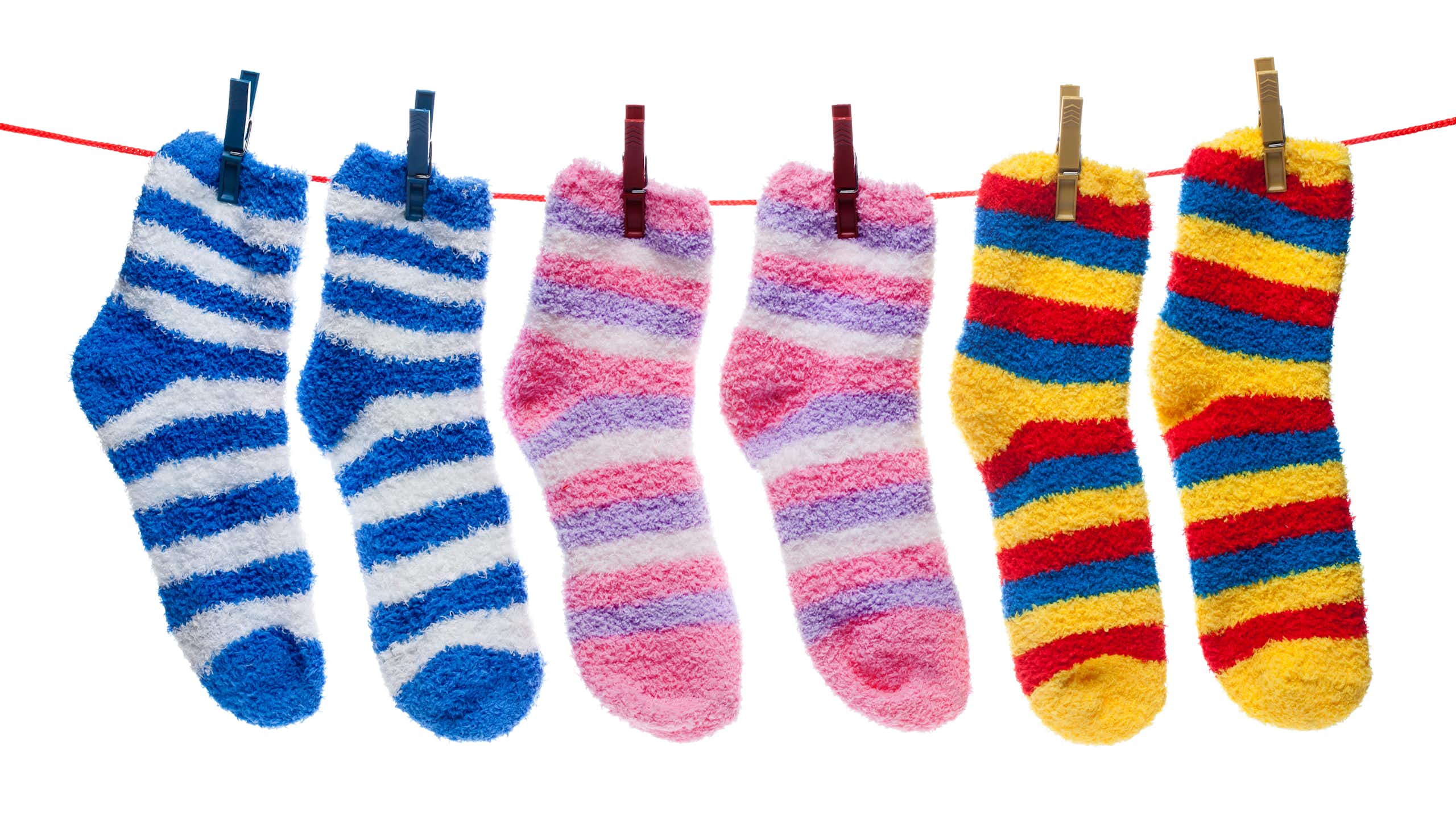 Striped fuzzy socks hanging on a clothes line