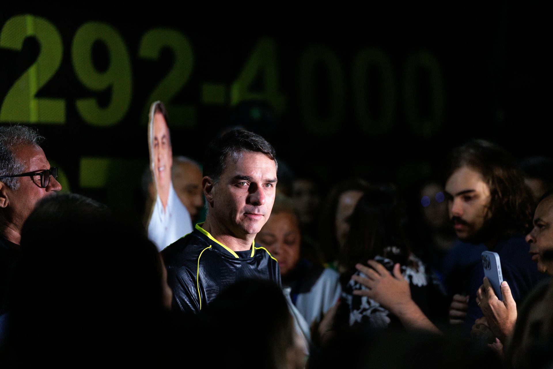 Flávio Bolsonaro participating in a vigil near the former Brazilian president's home.