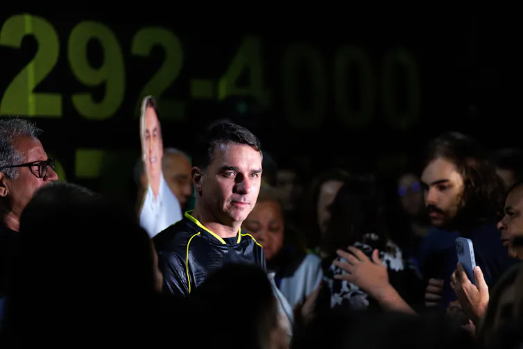 Flávio Bolsonaro participating in a vigil near the former Brazilian president's home.