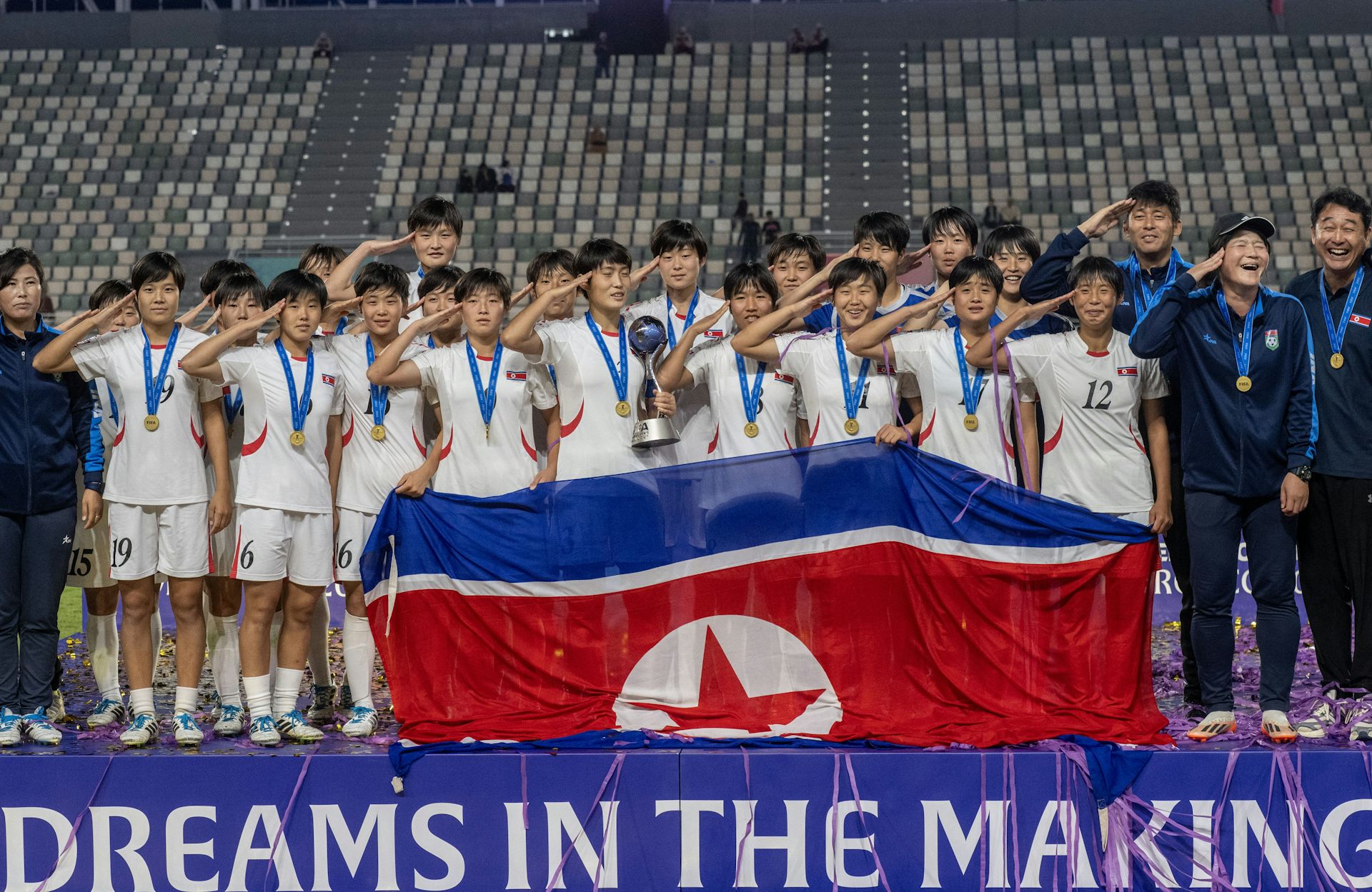 North Korean players celebrate with the trophy after winning the under-17 women's football World Cup.
