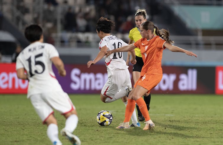 Women playing football.