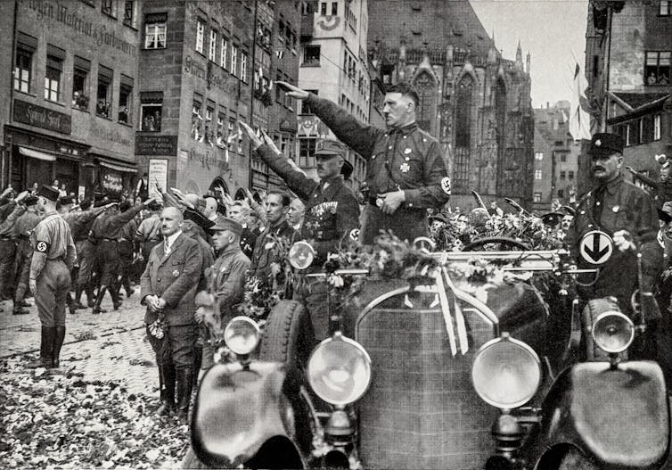 Racism by no means went away – it merely modified form 1 Adolf Hitler gives the Nazi salute from his car.