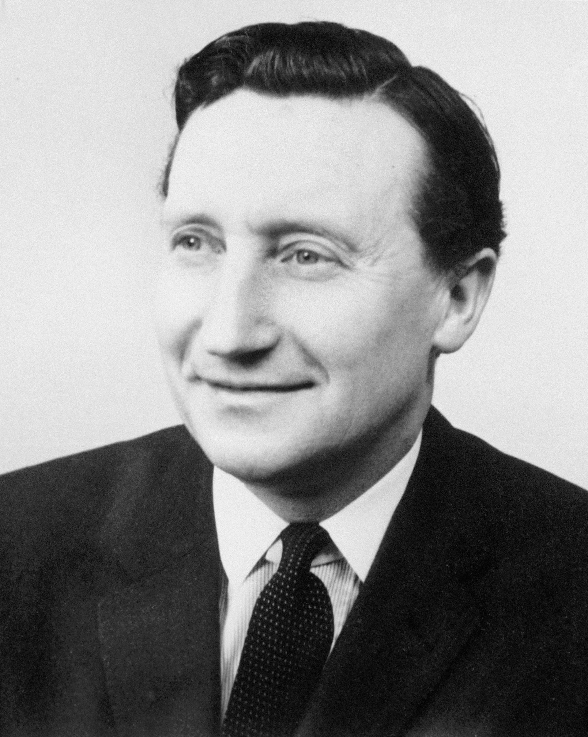 Black and white portrait photo of a man in a suit from 1965.