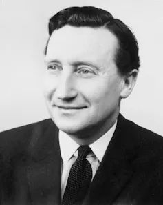 Black and white portrait photo of a man in a suit from 1965.
