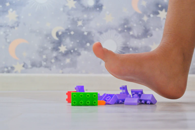 Stepping on toy bricks.