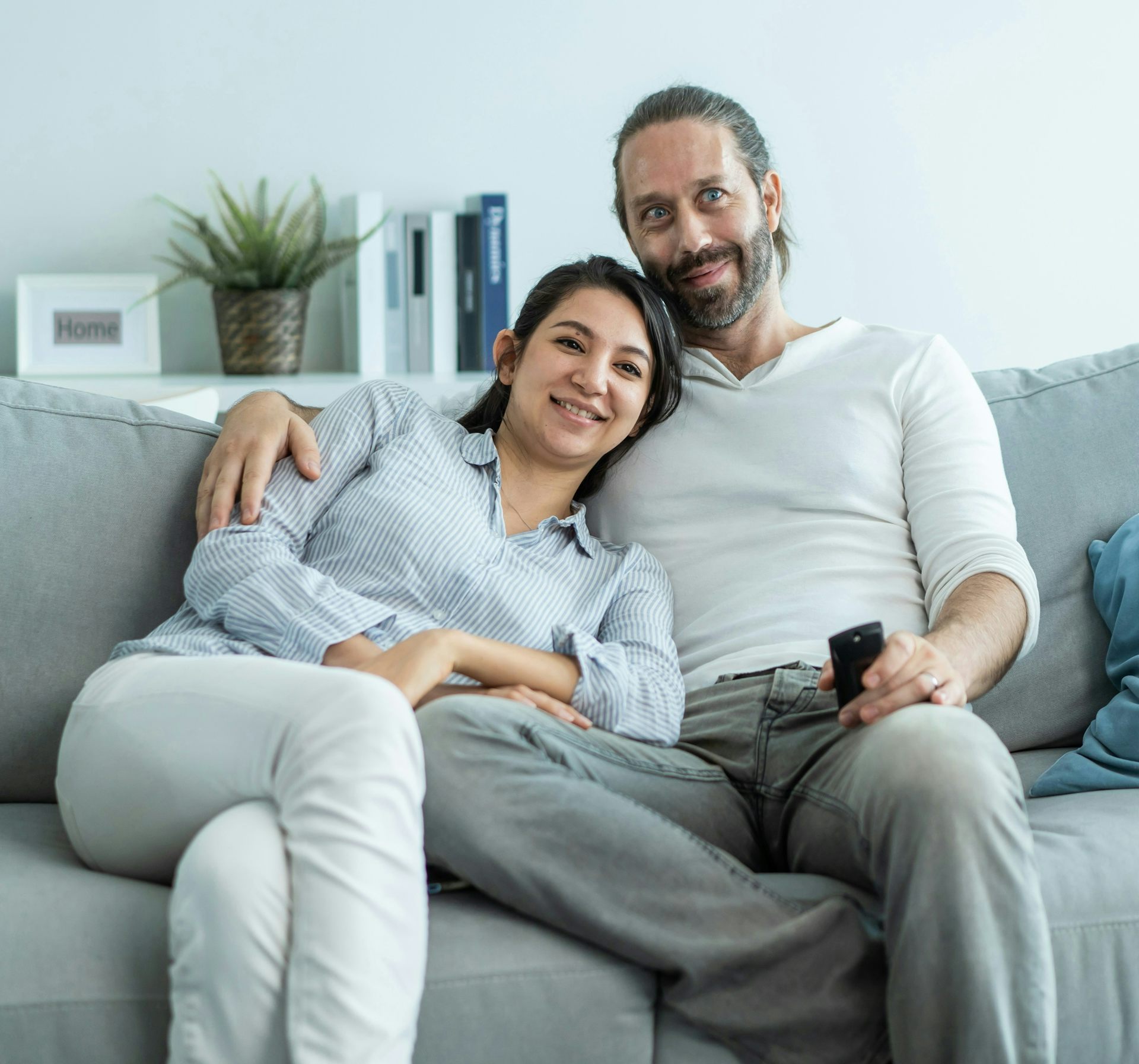 Una pareja sentada en el sofá viendo la televisión.