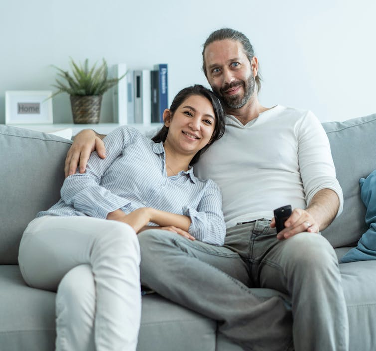 ¿Dependientes? Por qué Canadá debería reconocer con mayor precisión a los cónyuges y parejas de inmigrantes 1 Una pareja sentada en el sofá viendo la televisión.