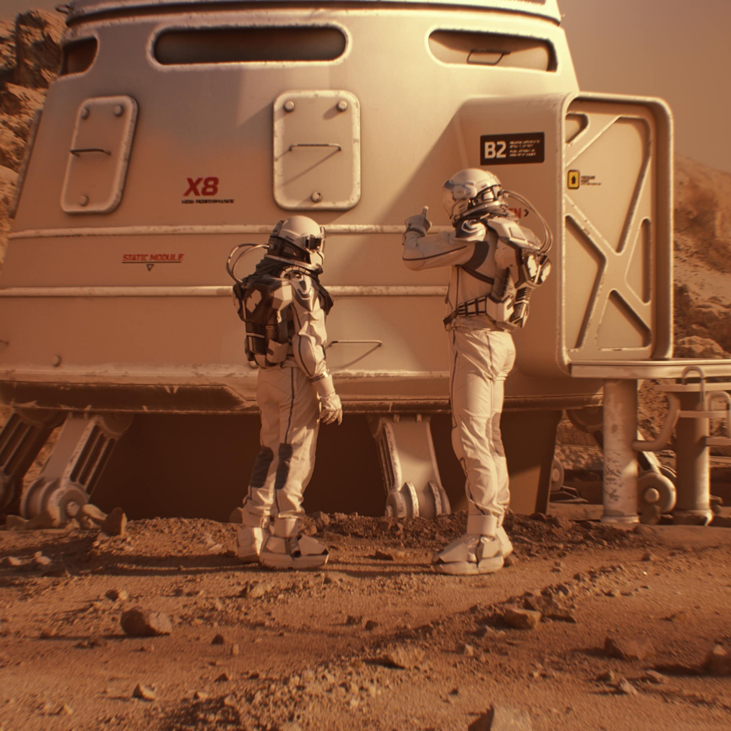 Two astronauts in spacesuits walk toward research station, colony or scientific base on Mars.