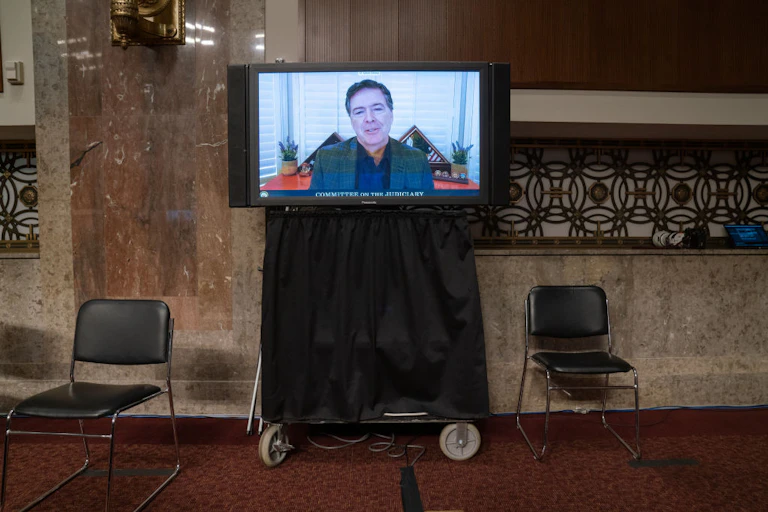 A man is seen on a television monitor.