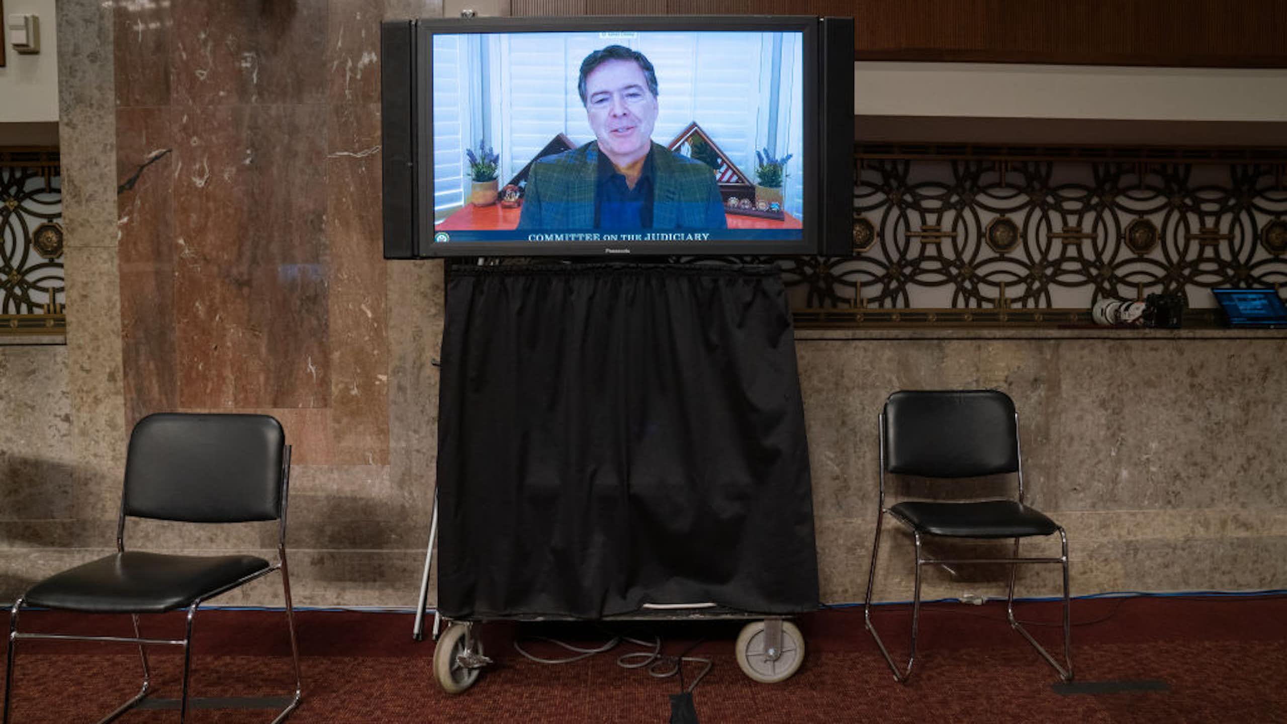 A man is seen on a television monitor.