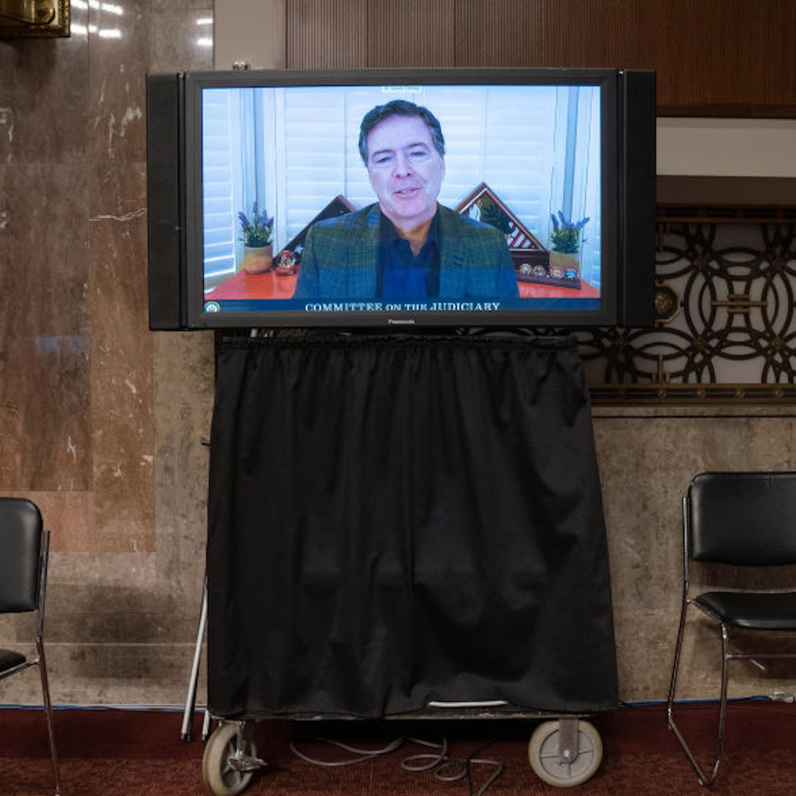 A man is seen on a television monitor.