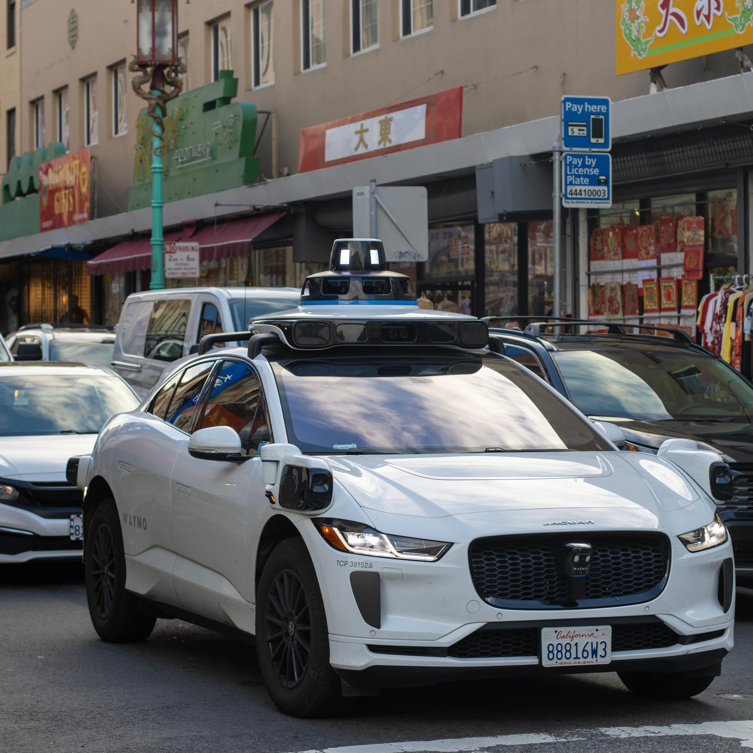 Driverless taxi in traffic.