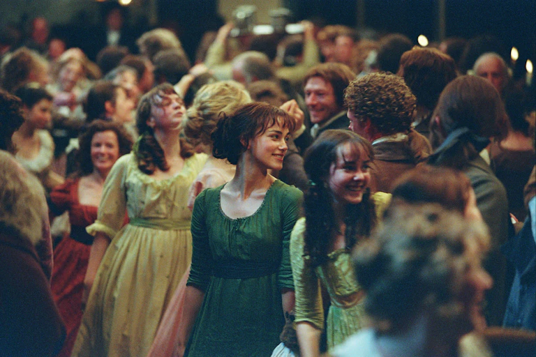 Several people dancing at a Regency ball