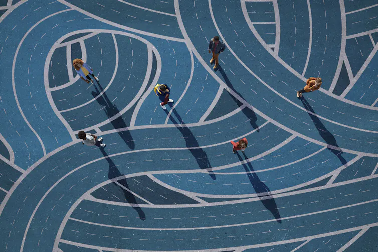 A blue circular maze shows people from above walking on different paths.
