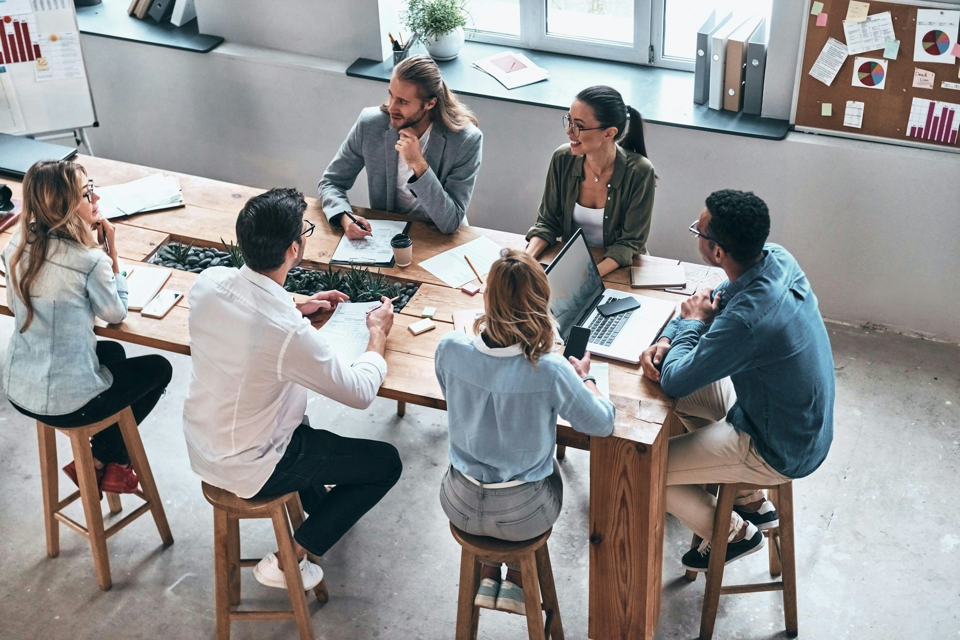 A group of people sitting around a table in an office