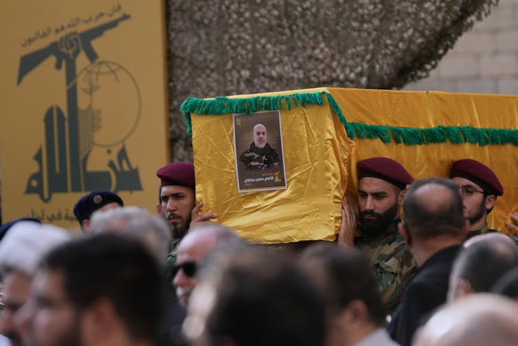 A yr on, the Israeli-Lebanese ceasefire seems more and more fragile − may just a go back to cyclical violence come subsequent? 2 Men carry coffin of military leader.