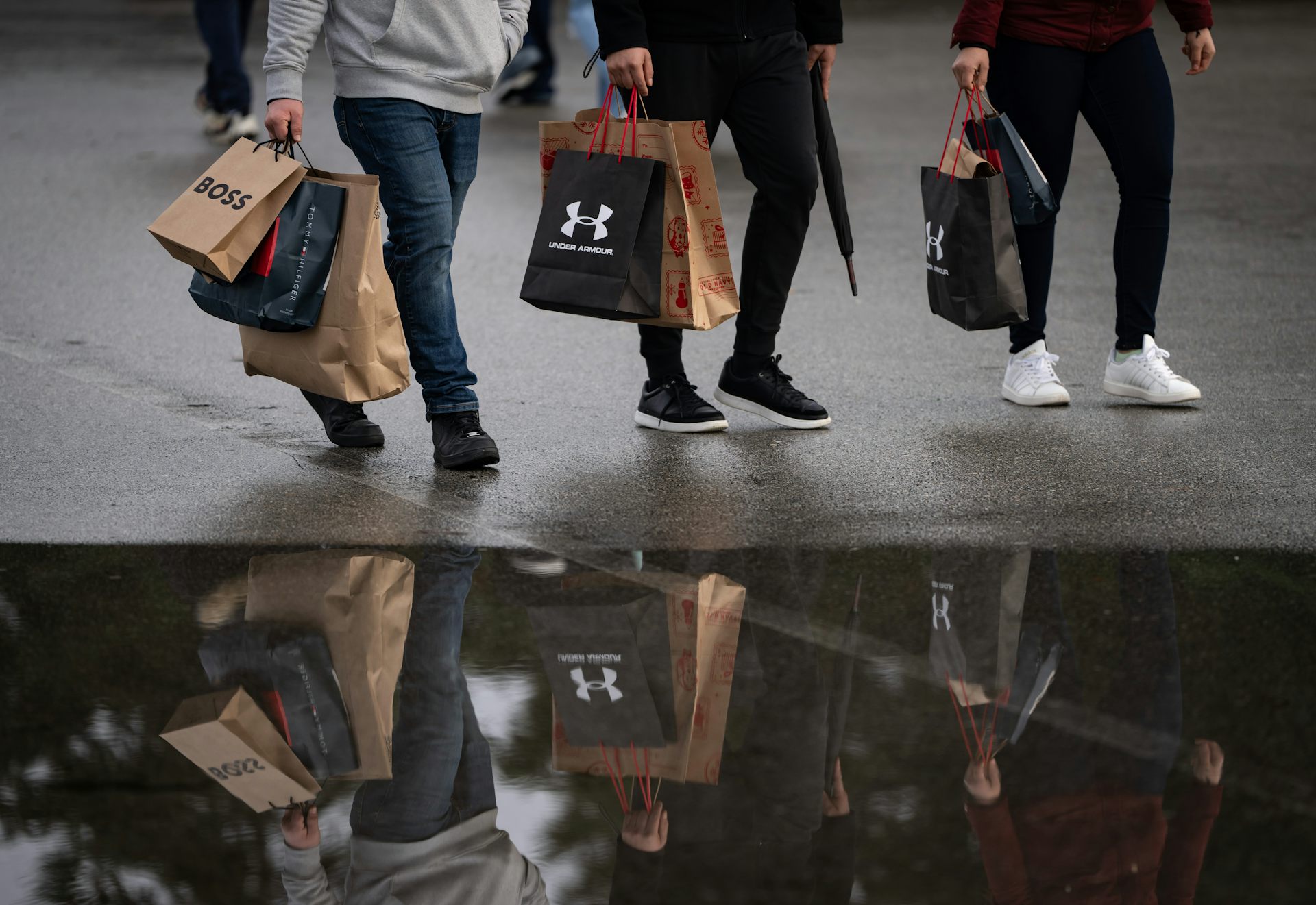 Three people walking with shopping bags