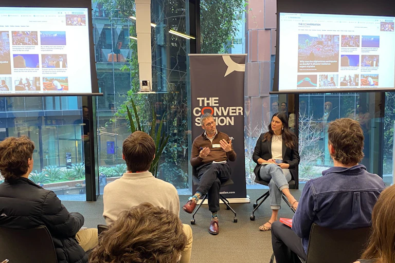 The Conversation's Editor Misha Ketchell and Head of Editorial Innovation Ashlynne McGhee address a crowd