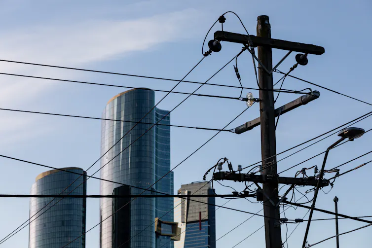 Electricity poles seen in front of skyscrapers in Melbourne