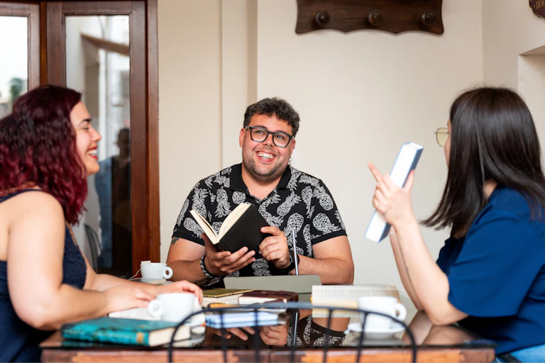 People with books round a table