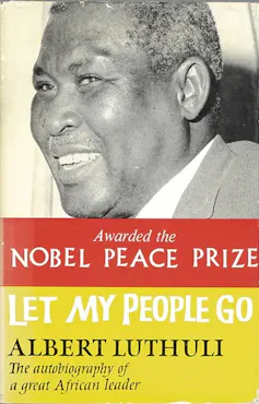 A vintage book cover with a black and white photo of a smiling African man, banners of red and yellow with mention of the Nobel Peace Prize, Let My People Go, Albert Luthuli.