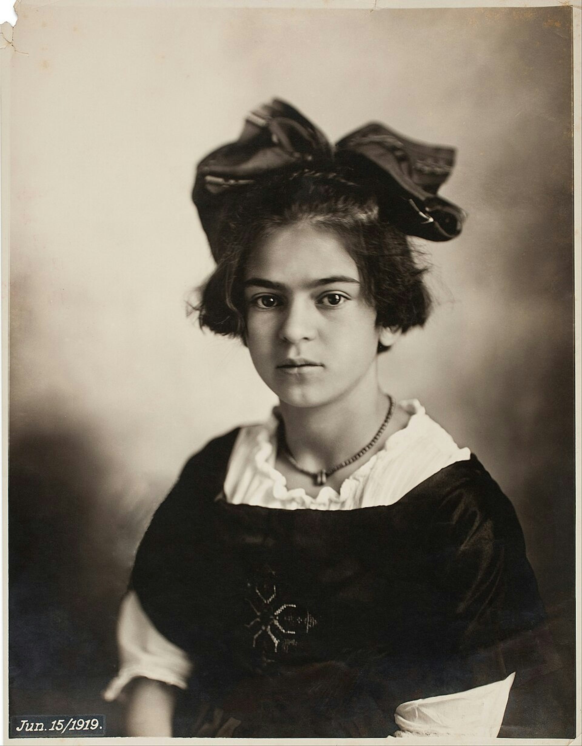A young girl with a large bow in her hair