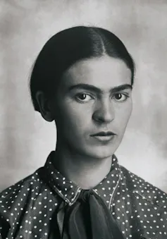 a young Frida Kahlo with hair smoothed back in a centre parting